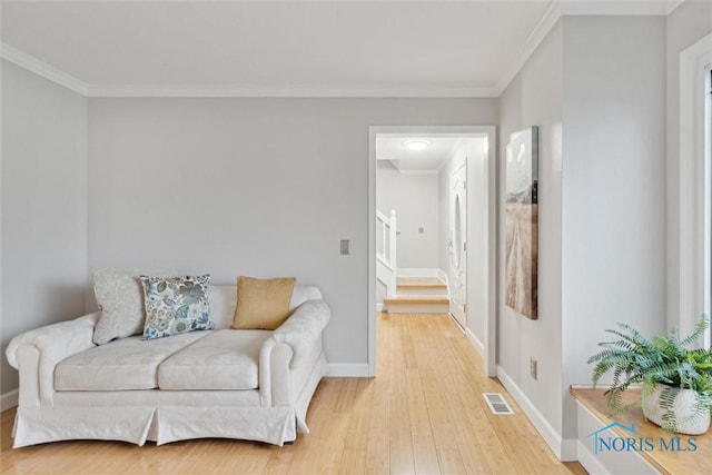 sitting room featuring hardwood / wood-style floors and ornamental molding