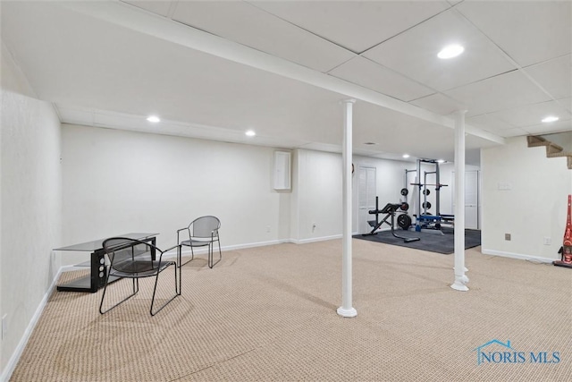 basement with carpet and a paneled ceiling