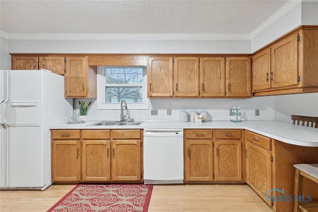 kitchen with sink, light hardwood / wood-style floors, white appliances, and ornamental molding