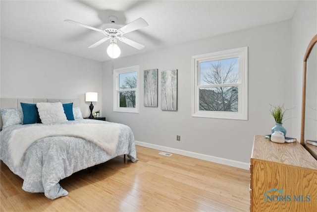 bedroom with ceiling fan and hardwood / wood-style floors