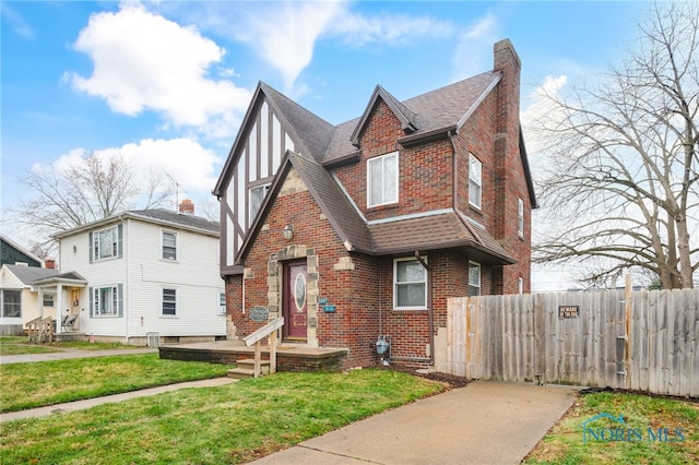 view of front of house featuring central AC and a front yard