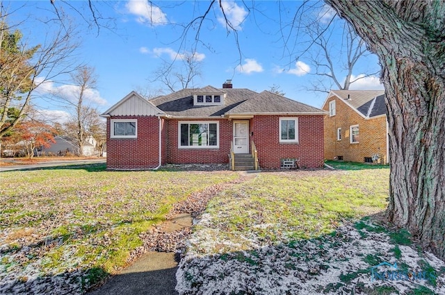 ranch-style home with a front lawn