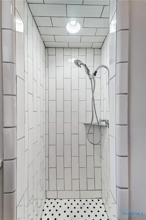 bathroom featuring a tile shower and tile patterned floors