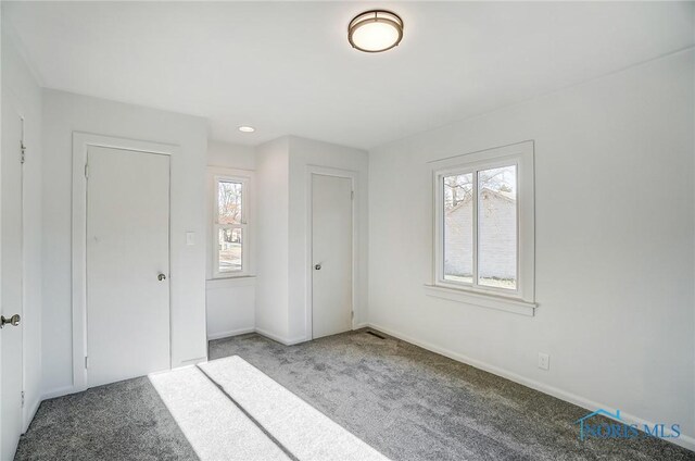 unfurnished bedroom with a closet and carpet