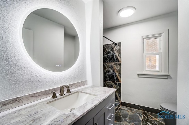 bathroom with vanity, toilet, and walk in shower