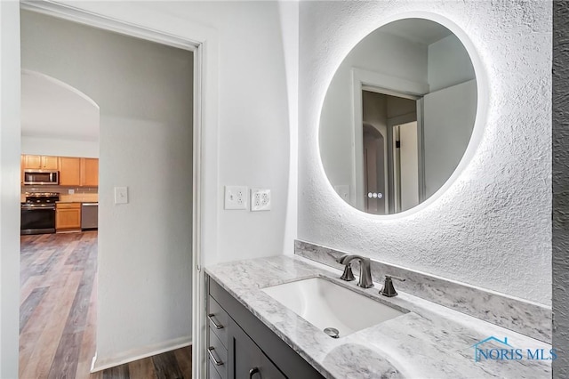 bathroom featuring hardwood / wood-style flooring and vanity