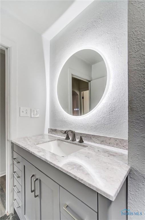 bathroom featuring vanity and wood-type flooring