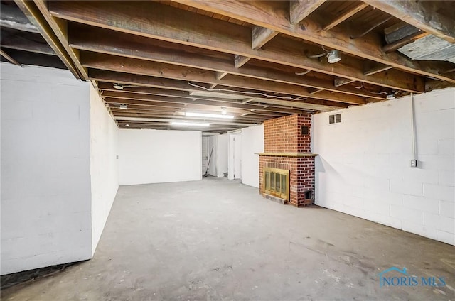 basement featuring a brick fireplace