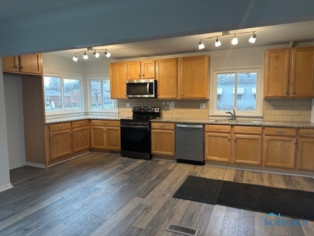 kitchen featuring plenty of natural light, appliances with stainless steel finishes, and tasteful backsplash