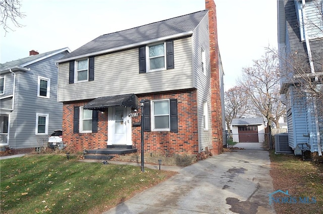 view of front of home with central air condition unit and a front lawn