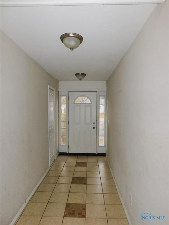 doorway with light tile patterned floors