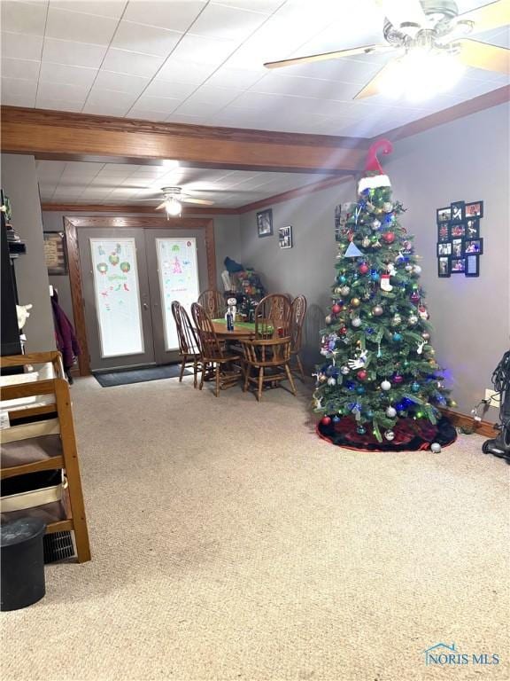 carpeted dining room with french doors and ceiling fan