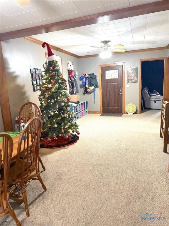 game room with carpet, ceiling fan, and ornamental molding