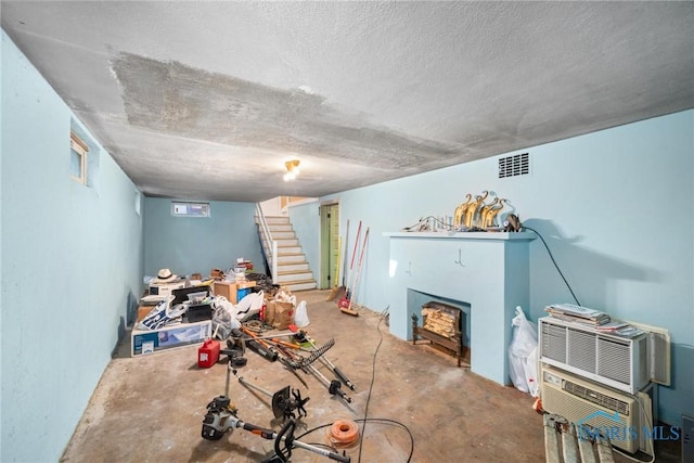 living room featuring concrete flooring and a textured ceiling