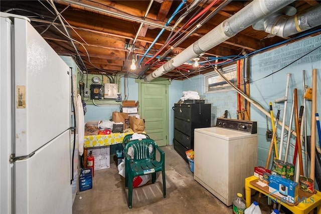 basement featuring washer / clothes dryer and white fridge