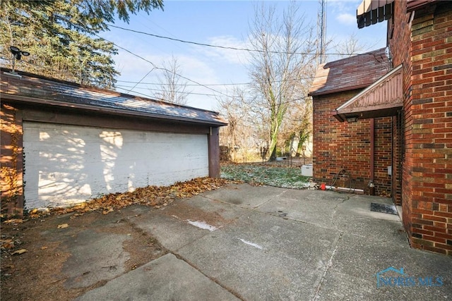 view of patio featuring an outdoor structure and a garage