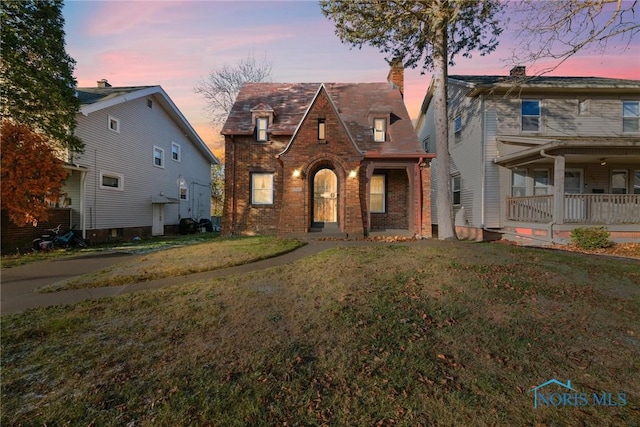 view of front of property with a lawn and covered porch