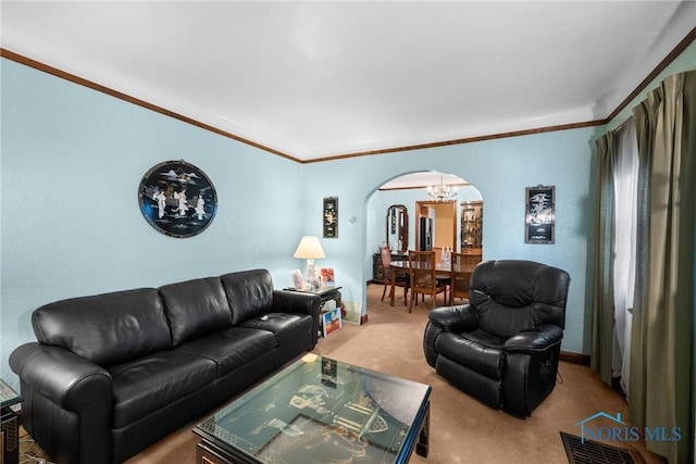 living room with carpet flooring, a notable chandelier, and ornamental molding