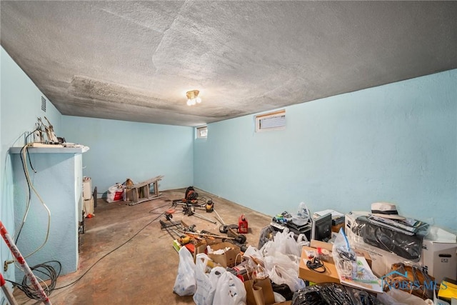 interior space featuring a textured ceiling and concrete floors