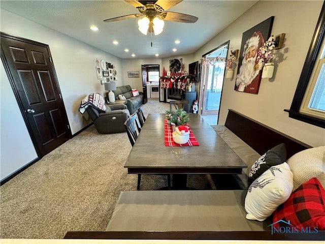 dining area featuring carpet floors and ceiling fan