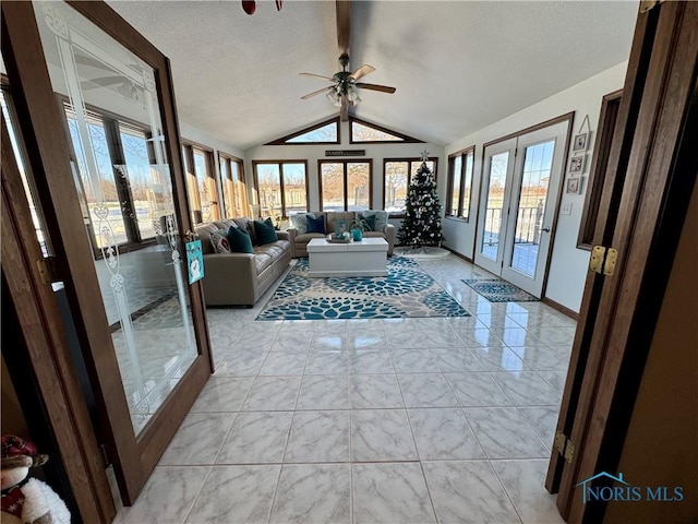 living room with ceiling fan, french doors, and lofted ceiling with beams