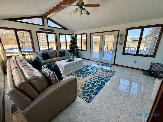 living room with plenty of natural light, lofted ceiling with beams, and ceiling fan