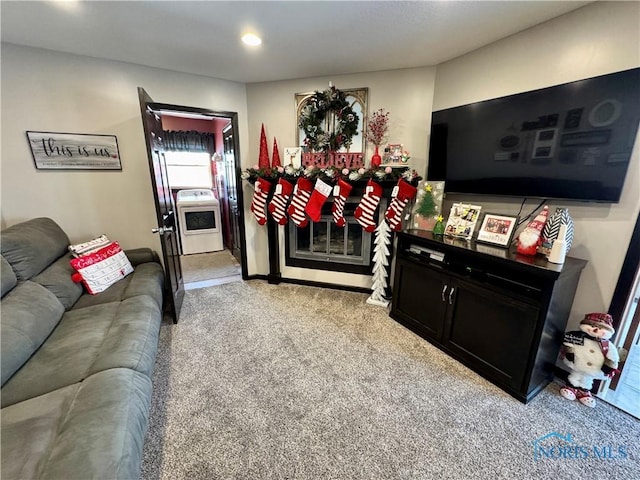 living room featuring light carpet and washer / clothes dryer