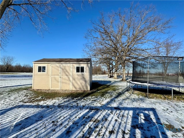 snow covered structure with a trampoline