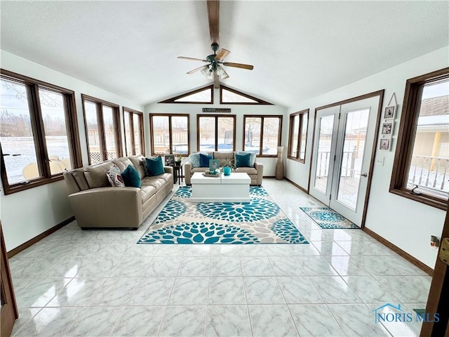 living room featuring ceiling fan and vaulted ceiling with beams