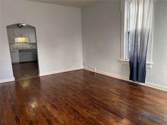 unfurnished room featuring dark wood-type flooring