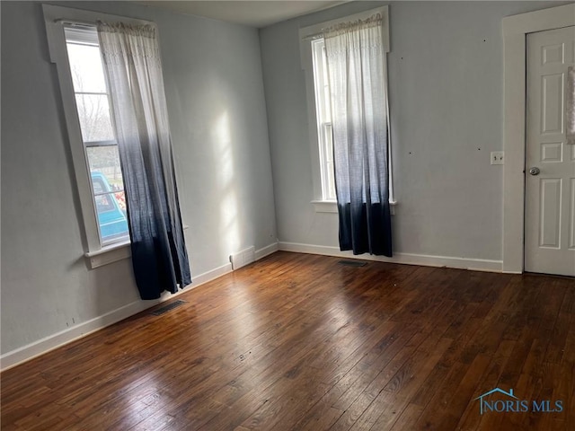 unfurnished room with dark hardwood / wood-style floors