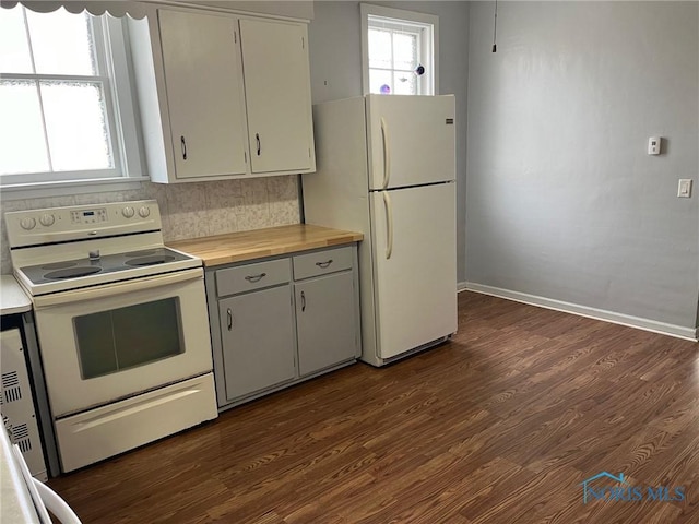 kitchen featuring dark hardwood / wood-style flooring, white appliances, white cabinetry, and backsplash