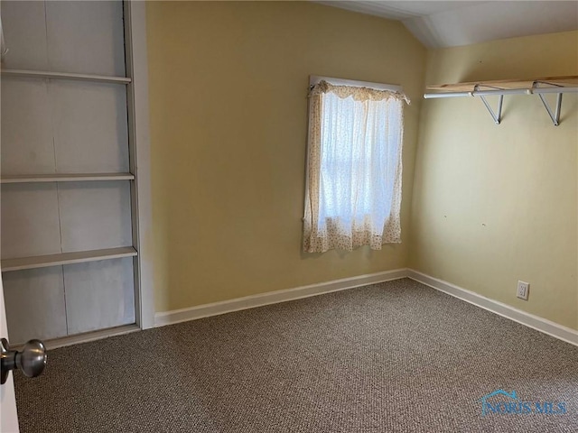 unfurnished bedroom with lofted ceiling and carpet floors