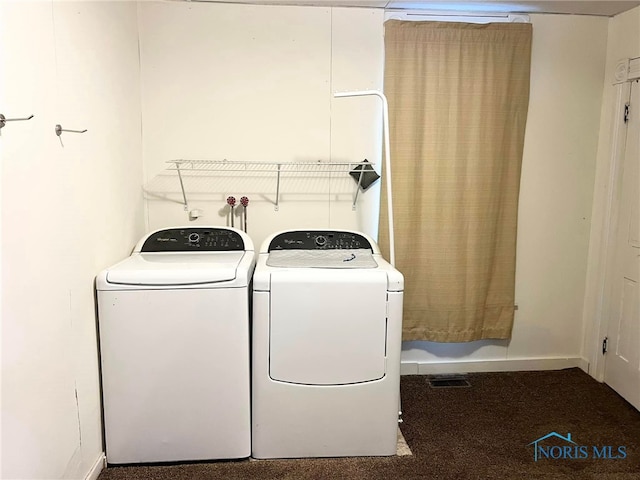 laundry room with washer and dryer and carpet floors