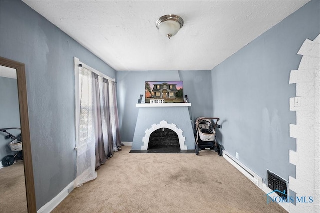 unfurnished living room with a fireplace, light colored carpet, and baseboard heating