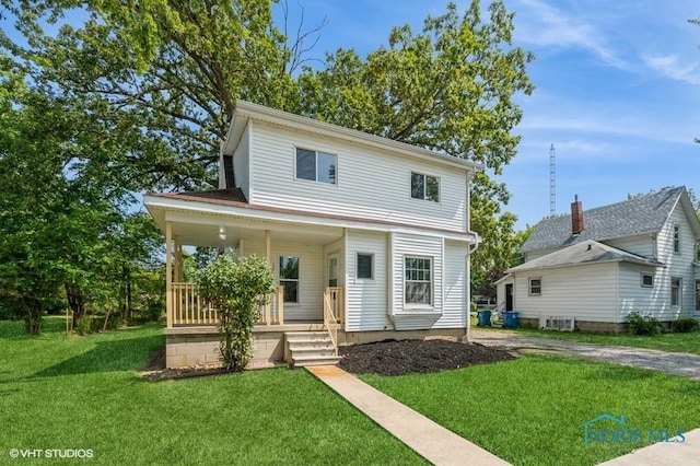 view of front of house featuring covered porch and a front yard