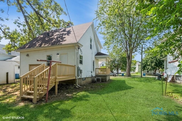 back of house with a yard, central AC, and a wooden deck