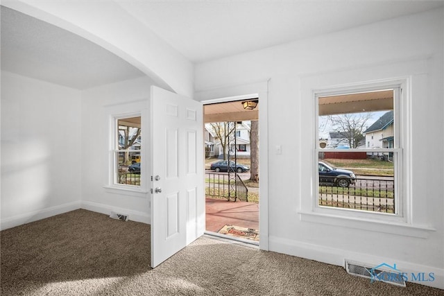 doorway to outside featuring carpet