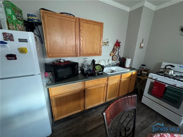 kitchen with crown molding, dark hardwood / wood-style flooring, white appliances, and sink