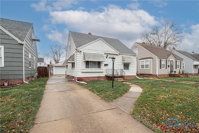 view of front of home with a front lawn, an outdoor structure, and a garage