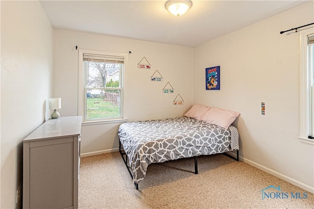 bedroom featuring light carpet