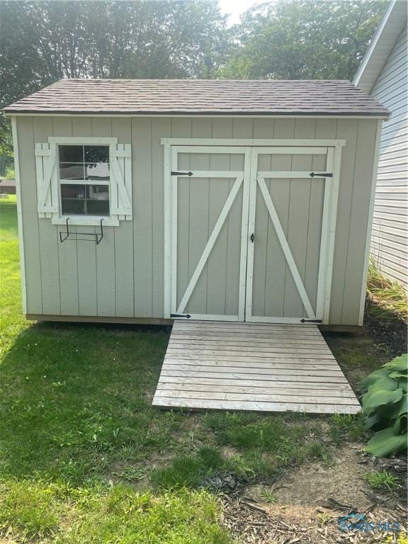 view of outbuilding with a lawn