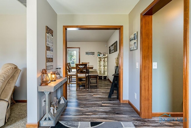 corridor with dark hardwood / wood-style flooring