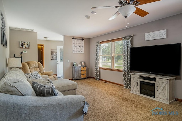 living room featuring carpet floors and ceiling fan