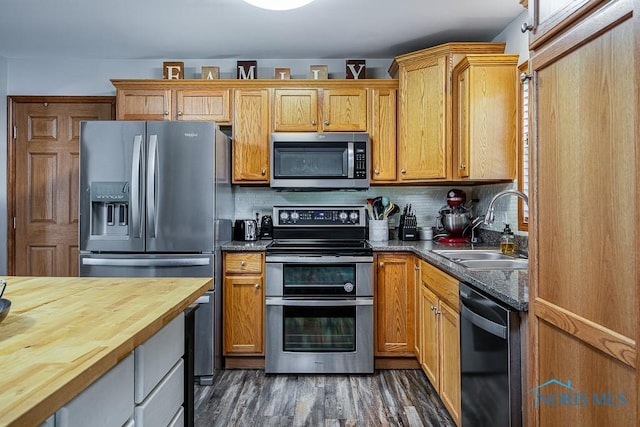 kitchen featuring dark hardwood / wood-style flooring, sink, stainless steel appliances, and tasteful backsplash