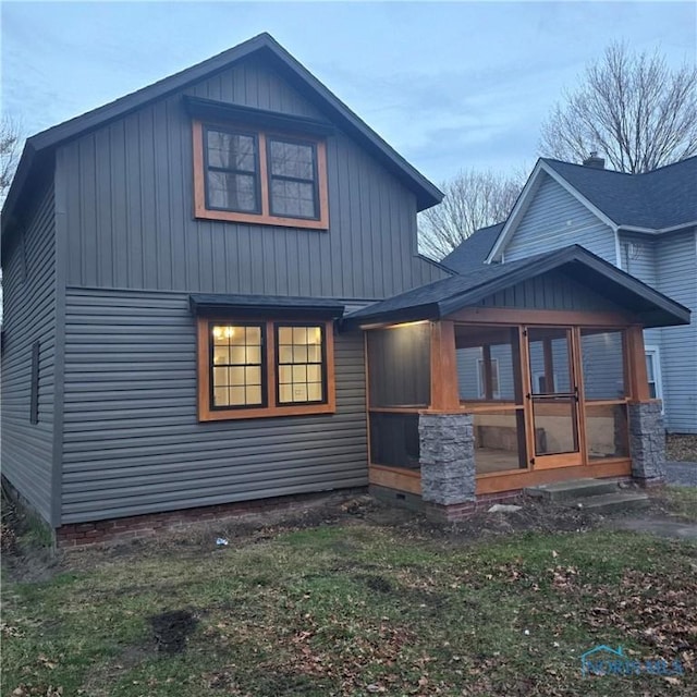 back of house featuring a sunroom