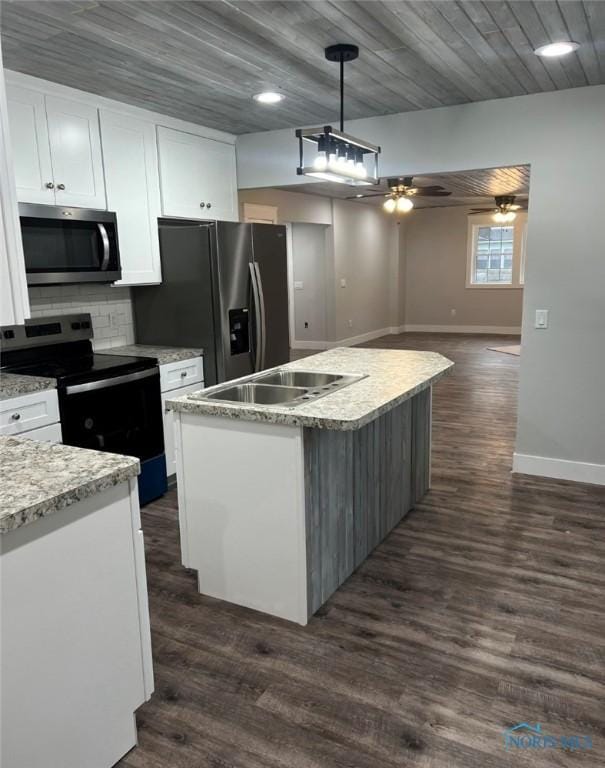 kitchen with a center island, hanging light fixtures, dark hardwood / wood-style floors, stainless steel appliances, and white cabinets