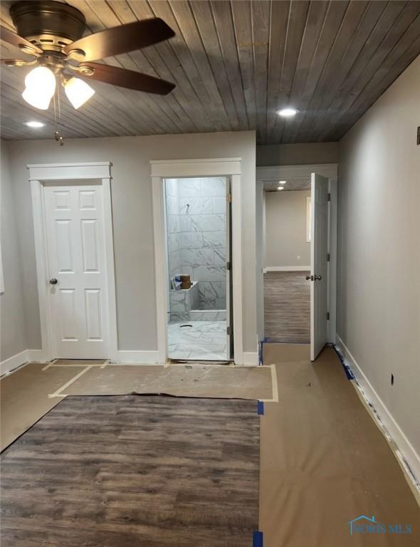 doorway with ceiling fan and wooden ceiling