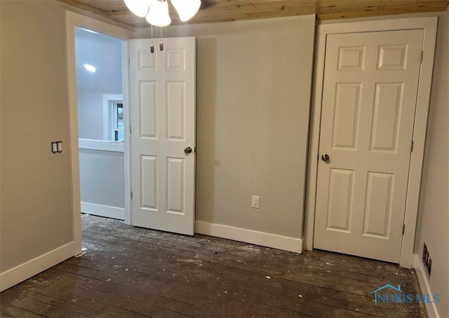 unfurnished bedroom featuring dark wood-type flooring