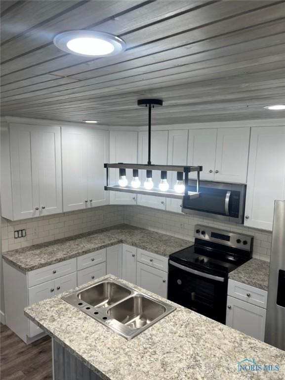 kitchen featuring sink, white cabinetry, tasteful backsplash, pendant lighting, and stainless steel appliances